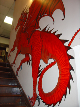 There is a big red dragon painted on the wall, on your way upstairs.